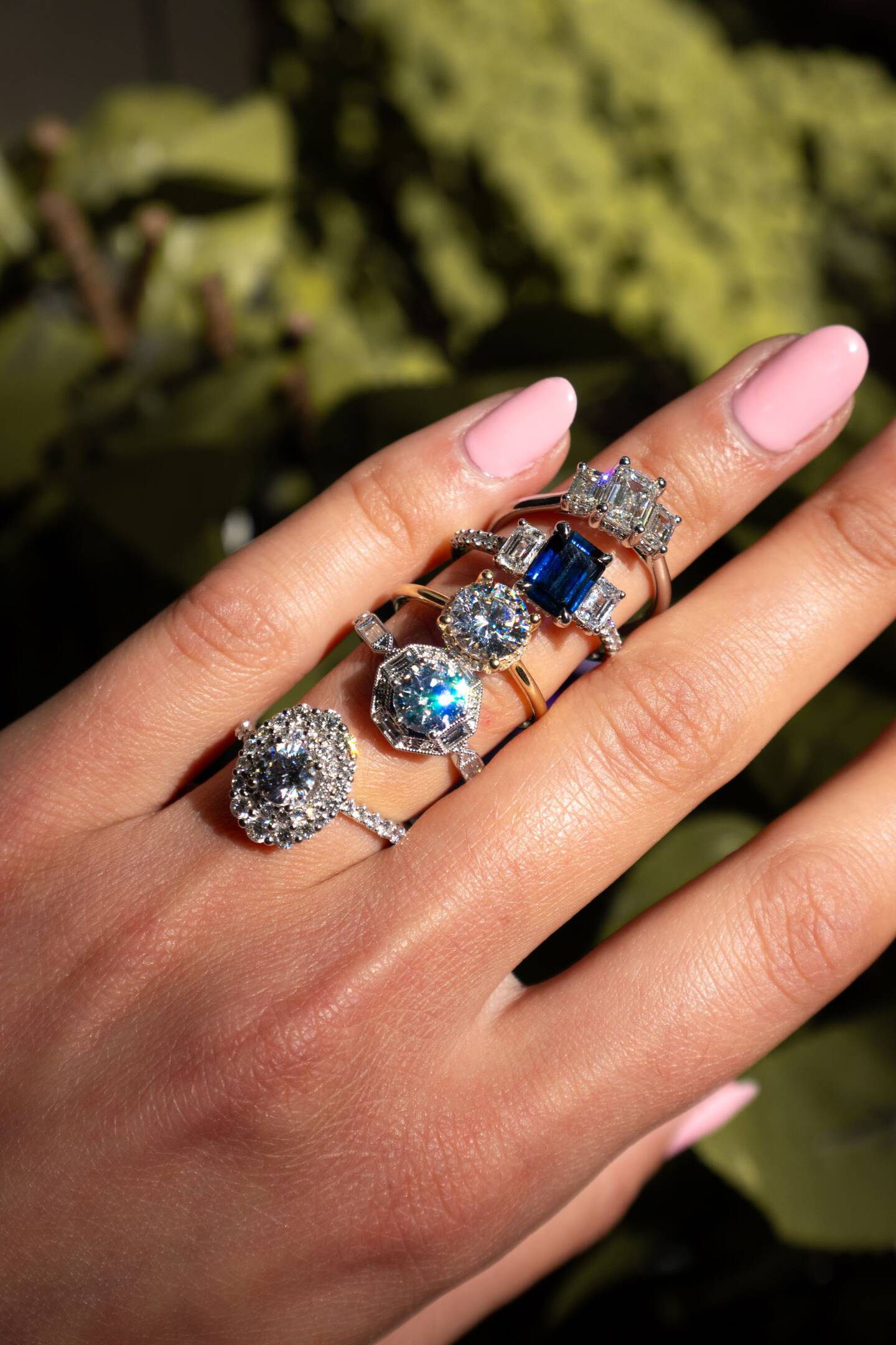 A woman hold up a hologram rendering of a custom engagement ring to demonstrate the mobile technology available